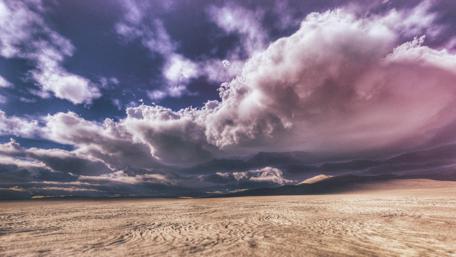 Desert Dreams Under Clouded Skies wallpaper