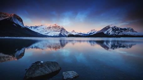 Mountain Peaks Reflecting in Tranquil Evening Lake wallpaper