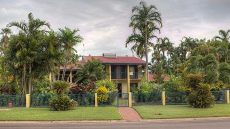 Serene House Surrounded by Lush Greenery wallpaper