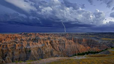 Stormy Skies Over Rugged Terrain wallpaper