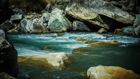 Serene River Flow Over Rocks and Pebbles wallpaper