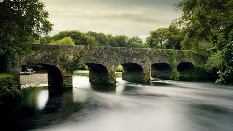 Stone Bridge Over Serene River in Killarney National Park wallpaper