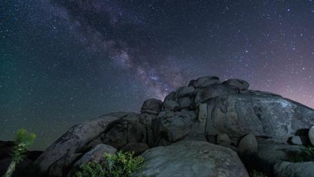 Starry Night Over Rocky Terrain wallpaper