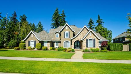 Charming Mansion Surrounded by Lush Greenery wallpaper