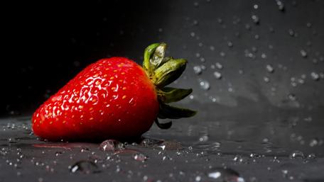 Glistening Red Strawberry in the Dark wallpaper