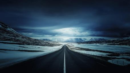 Majestic Icelandic Road Under Cloudy Skies wallpaper