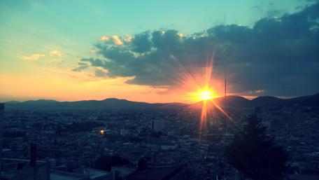 Cityscape at Sunset with Vibrant Colors and Light Effects wallpaper