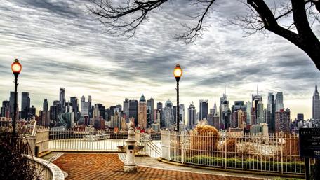 Majestic New York City Skyline Under Cloudy Skies wallpaper