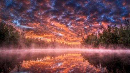 Fiery Sunrise Over Misty Lake wallpaper