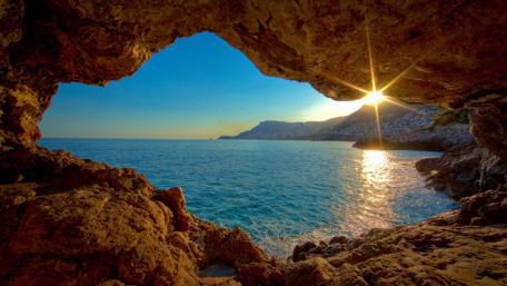 Sunlit Sea Cave Entrance wallpaper