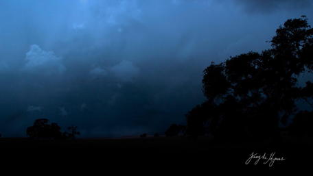 Majestic Stormy Skies Over Serene Landscape wallpaper