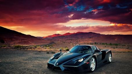 Stunning Ferrari Against a Majestic Sunset Landscape wallpaper