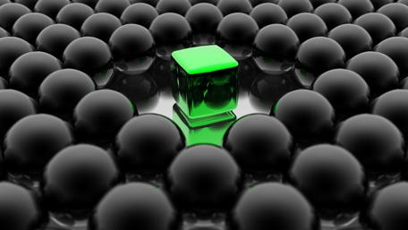 Vibrant Green Cube Among Dark Spheres wallpaper