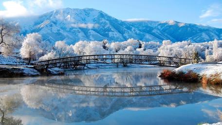 Winter Reflections: Snowy Bridge and Mountain Vista wallpaper