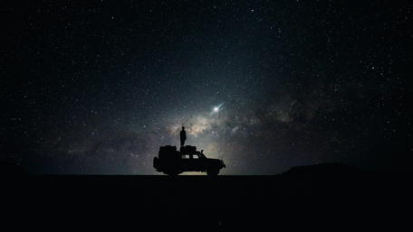 Stargazer's Serenity Beside a Lone Vehicle wallpaper