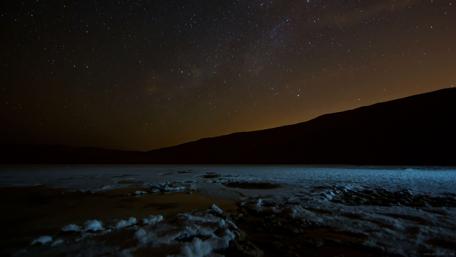 Starry Night Over Snowy Landscape wallpaper