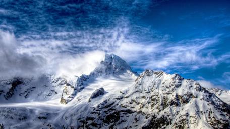 Majestic Snow-Capped Peaks Inviting Tranquility wallpaper