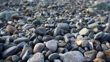 Serene Grey Pebbles by the Ocean Shore wallpaper