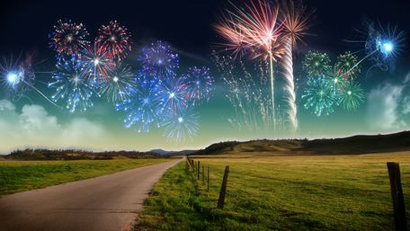 Joyful New Year Celebration Under Fireworks Sky wallpaper