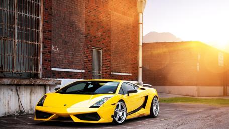 Sleek Yellow Lamborghini in Urban Setting wallpaper