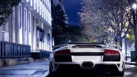 Sleek Lamborghini in Night Cityscape Scene wallpaper