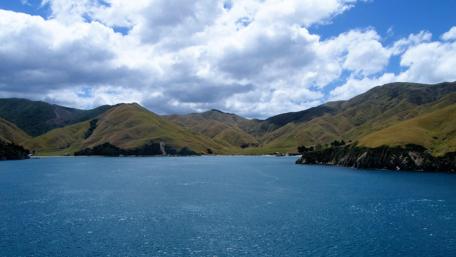 Serene New Zealand Landscape Amidst Majestic Mountains and Clouds wallpaper