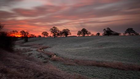 Serene Frosty Sunset Over a Tranquil Landscape wallpaper