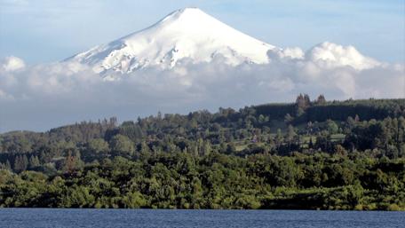 Majestic Snow-Capped Volcano Under Serene Clouds wallpaper