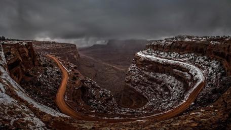 Endless Canyon Road Under Cloudy Skies wallpaper