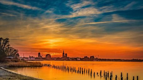 Golden Sunset Over a Vibrant Cityscape wallpaper