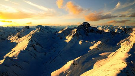 Majestic Sunrise Over Snowy Mountains wallpaper