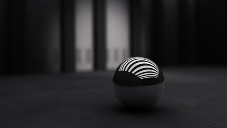 Sleek Monochrome Sphere in Dim Light wallpaper