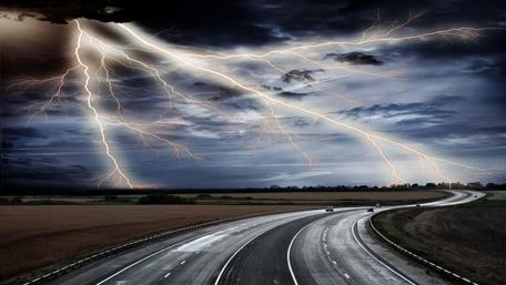 Lightning Strikes Over Open Highway at Night wallpaper