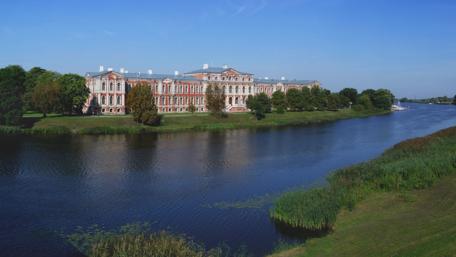 Serene View of Jelgava Castle Riverbank Landscape wallpaper