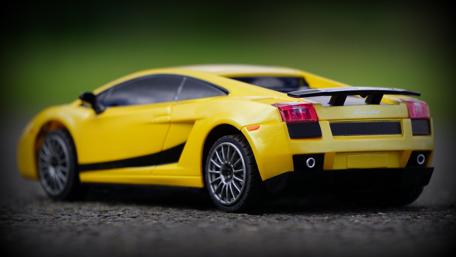 Vibrant Yellow Toy Car Elegance Showcase wallpaper