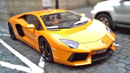 Sleek Yellow Lamborghini in Urban Setting wallpaper