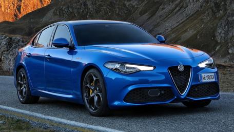 Dynamic Alfa Giulia on a Scenic Road wallpaper
