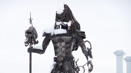 Snowy Metal Giant Stands Tall in Winter Wonder wallpaper