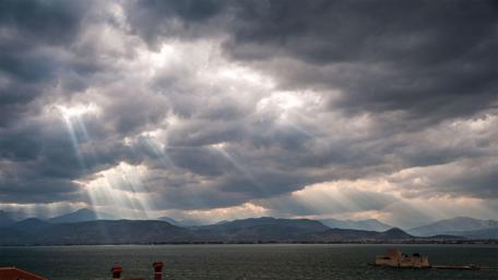 Sunrays Piercing Through Cloudy Skies wallpaper