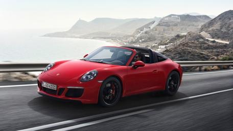 Stylish Porsche Driving Along Coastal Roads wallpaper