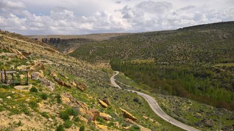 Winding Road Through Scenic Hillside Landscape wallpaper