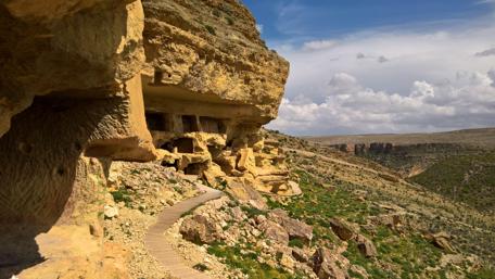 Serene Cliffside Cave Retreat in Nature's Embrace wallpaper