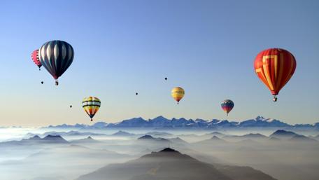 Soaring Above Vibrant Peaks and Skies wallpaper