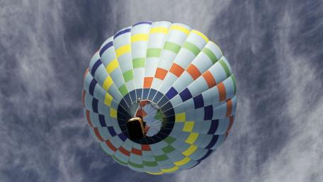 Colorful Hot Air Balloon Floating in Clear Skies wallpaper