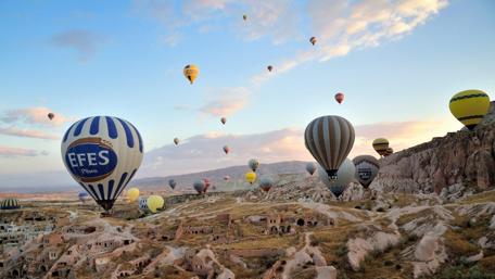 Majestic Hot Air Balloons Over Turkish Hills wallpaper