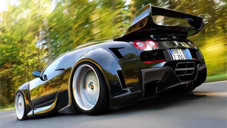 Sleek Black Supercar in Motion wallpaper