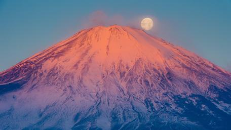 Majestic Full Moon Over Mount Fuji's Snowy Peak wallpaper
