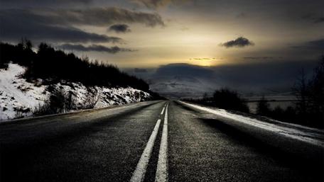 Mysterious Night Road in the Snowy Mountains wallpaper