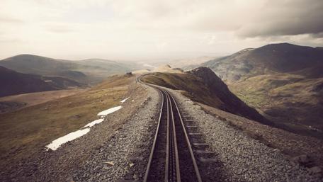Winding Track Through Majestic Mountains wallpaper
