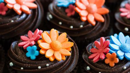 Chocolate Cupcake Delight with Floral Toppers wallpaper